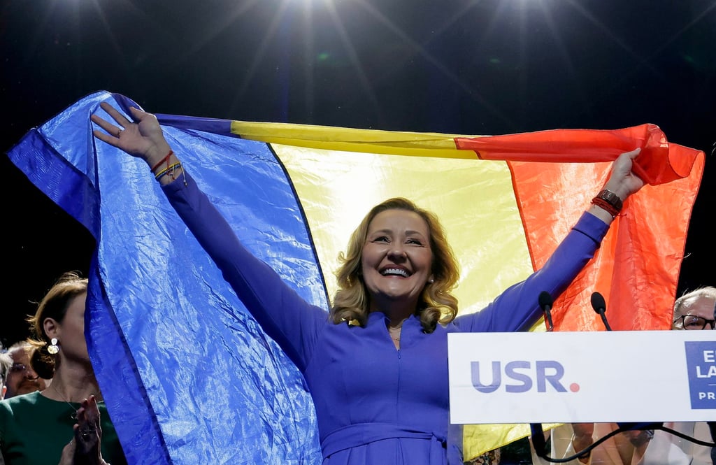 Elena Lasconi, leader of the USR (Save Romania Union) party and presidential candidate, waves a Romanian flag in front of supporters in Bucharest, Romania on Monday. Photo: EPA-EFE