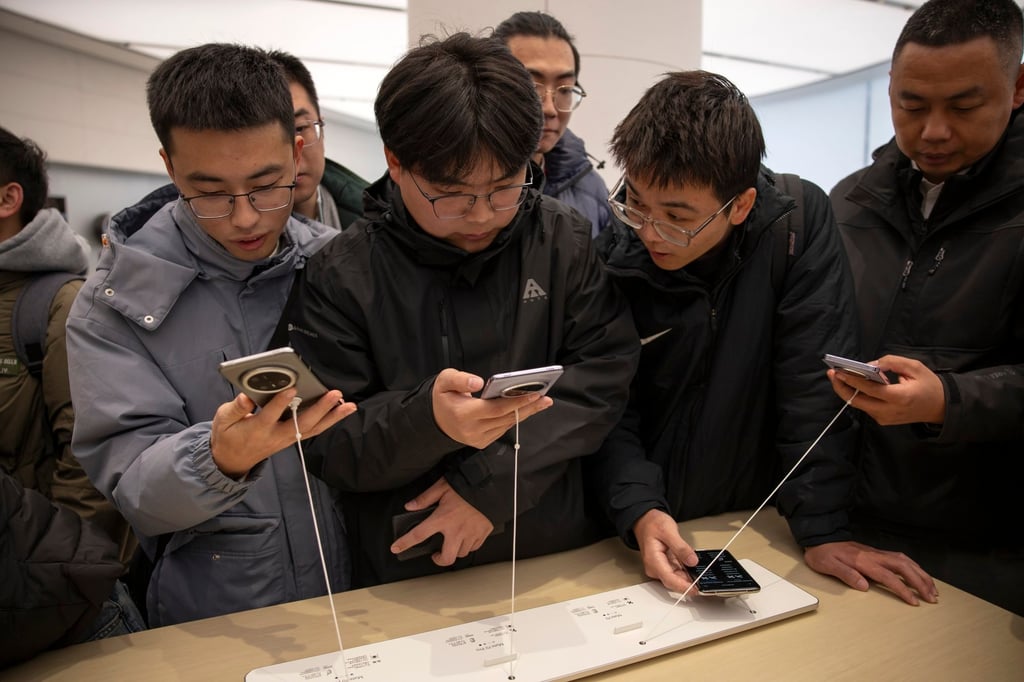 Visitors check out Huawei’s Mate 70 smartphones at a store in Beijing. Photo: EPA-EFE Visitors check out Huawei’s Mate 70 smartphones at a store in Beijing. Photo: EPA-EFE