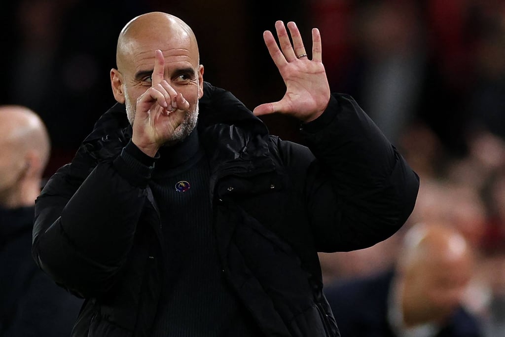 Pep Guardiola reacts to Liverpool fans during his side’s defeat at Anfield. Photo: AFP
