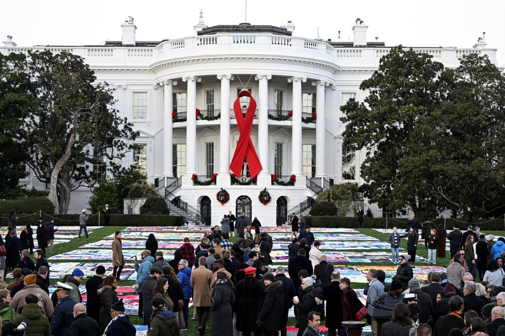 People walk past the Aids Memorial Quilt on display for the first time on the South Lawn of the White House on Sunday in Washington. Photo: Reuters