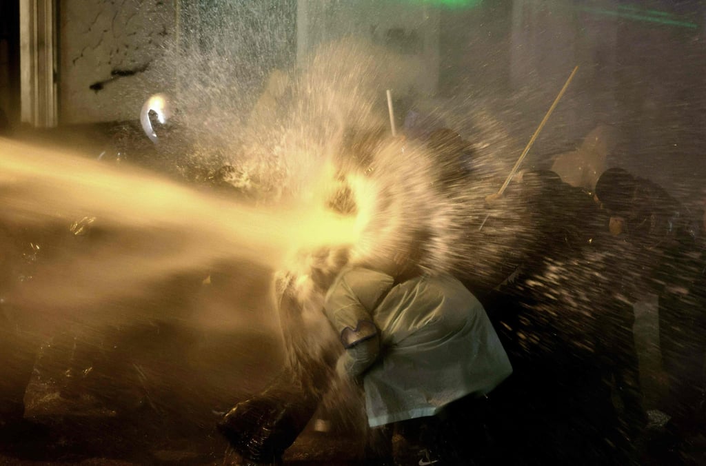 Police use water cannons to disperse demonstrators. Photo: AFP Police use water cannons to disperse demonstrators. Photo: AFP