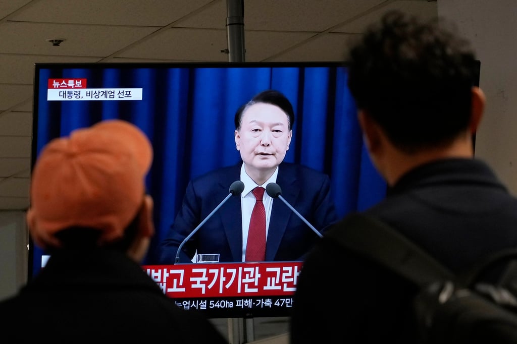 People watch South Korean President Yoon Suk-yeol’s televised briefing at a bus terminal in Seoul, South Korea, on Tuesday. Photo: AP People watch South Korean President Yoon Suk-yeol’s televised briefing at a bus terminal in Seoul, South Korea, on Tuesday. Photo: AP