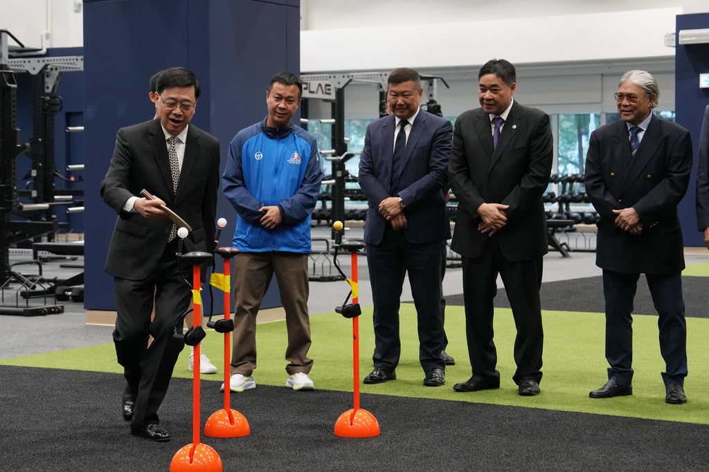 Chief Executive John Lee tries his hand at a table tennis drill in the New Facilities Building. Photo: Elson Li Chief Executive John Lee tries his hand at a table tennis drill in the New Facilities Building. Photo: Elson Li
