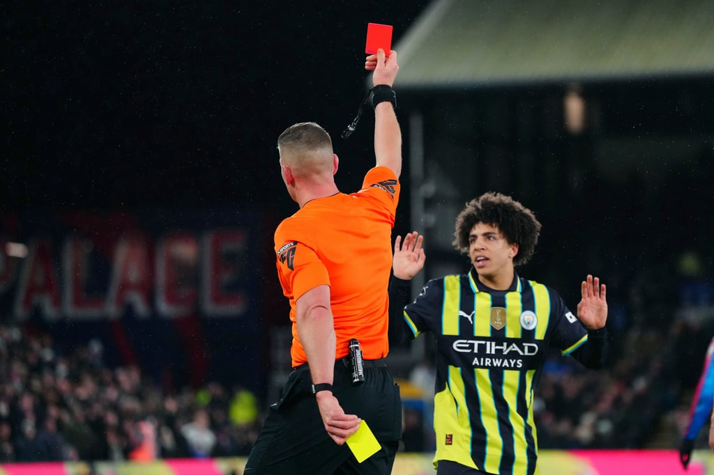 Manchester City’s Rico Lewis is sent off by referee Rob Jones at Selhurst Park. Photo: AP