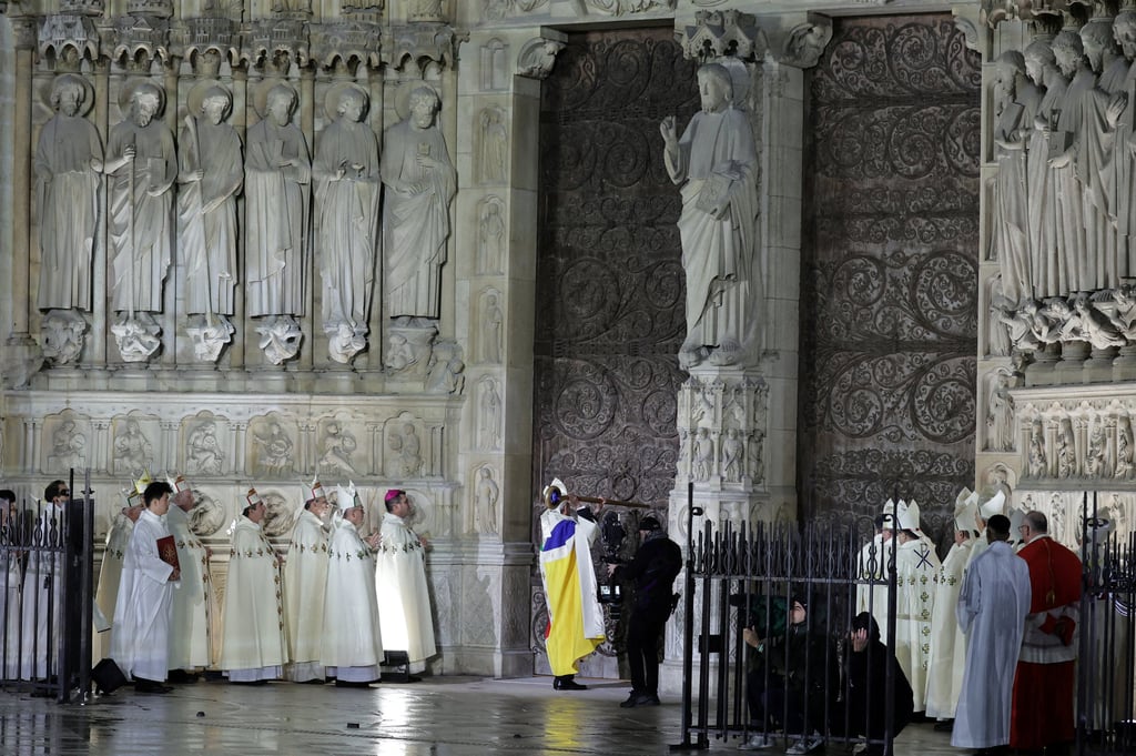 Paris’ archbishop Laurent Ulrich inaugurates the Notre Dame de Paris Cathedral by knocking on the doors during the reopening ceremony of the Notre Dame de Paris Cathedral. Photo: Reuters
