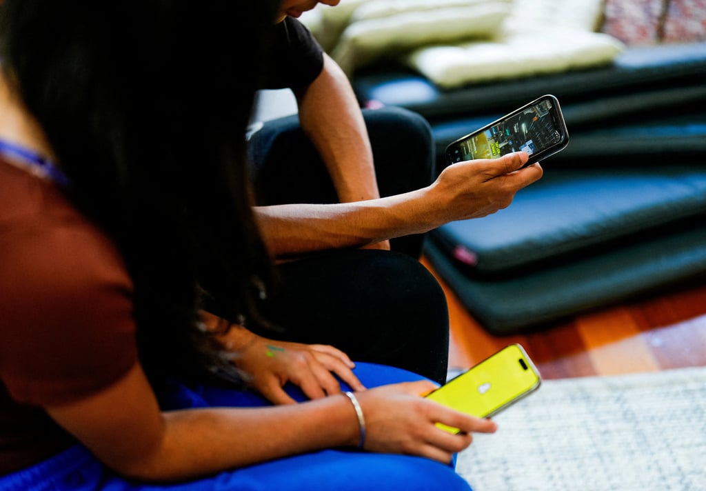 School students in Melbourne use social media applications on their smartphones. Photo: Reuters