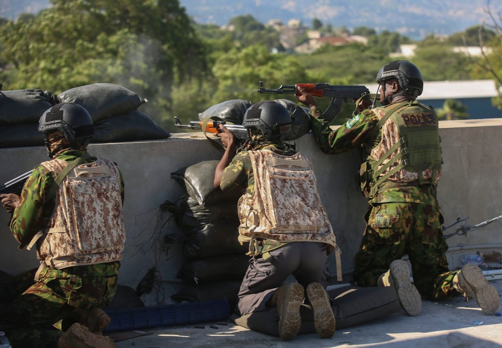 Kenyan police officers, part of a UN-backed multinational force, exchange fire with gang members in Port-au-Prince, Haiti. Photo: AP