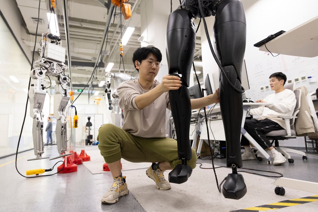 A technician adjusts CASBOT 01, a humanoid robot, at a laboratory in Beijing, November 12, 2024. Photo: Xinhua