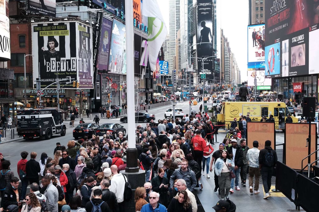People wait in line to buy theatre tickets in Times Square. The US tourism industry has had a slow year, with companies such as Hilton and Airbnb bracing for weaker revenue. Photo: AFP People wait in line to buy theatre tickets in Times Square. The US tourism industry has had a slow year, with companies such as Hilton and Airbnb bracing for weaker revenue. Photo: AFP