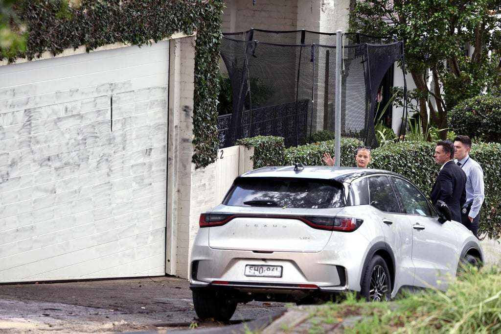 New South Wales Premier Chris Minns (second from right) inspects the area where anti-Israel graffiti was written on a wall in the Sydney suburb of Woollahra on Wednesday. Photo: AFP