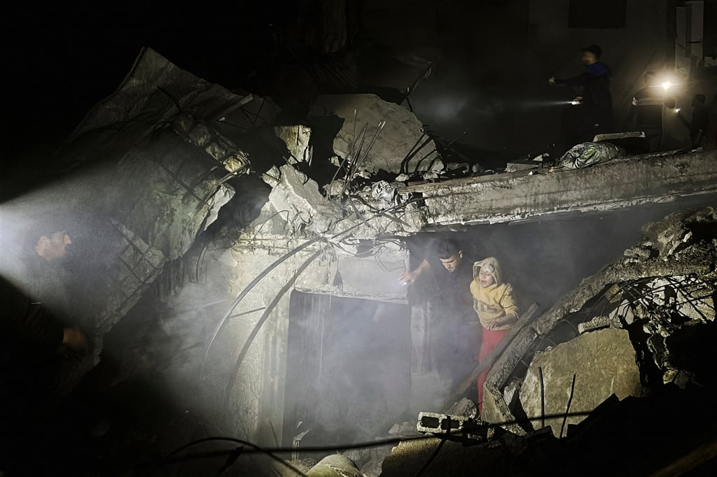People make their way through rubble following an Israeli strike at a post office in Nuseirat in central Gaza Strip. Photo: Reuters People make their way through rubble following an Israeli strike at a post office in Nuseirat in central Gaza Strip. Photo: Reuters
