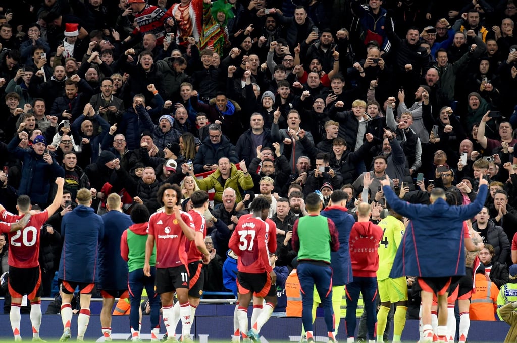 Manchester United players celebrate with their supporters after clinching victory over Manchester City in dramatic fashion. Photo: AP