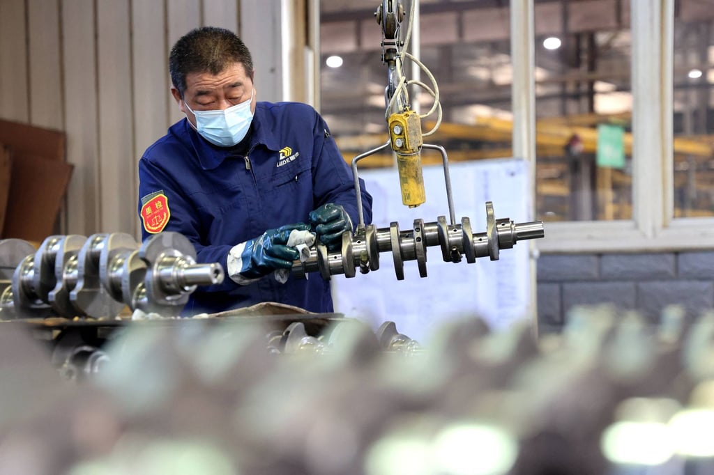 A quality inspector checks crankshafts at a factory which produces the mechanical component for both the domestic market and export in Binzhou in China’s eastern Shandong province. Photo: AFP A quality inspector checks crankshafts at a factory which produces the mechanical component for both the domestic market and export in Binzhou in China’s eastern Shandong province. Photo: AFP