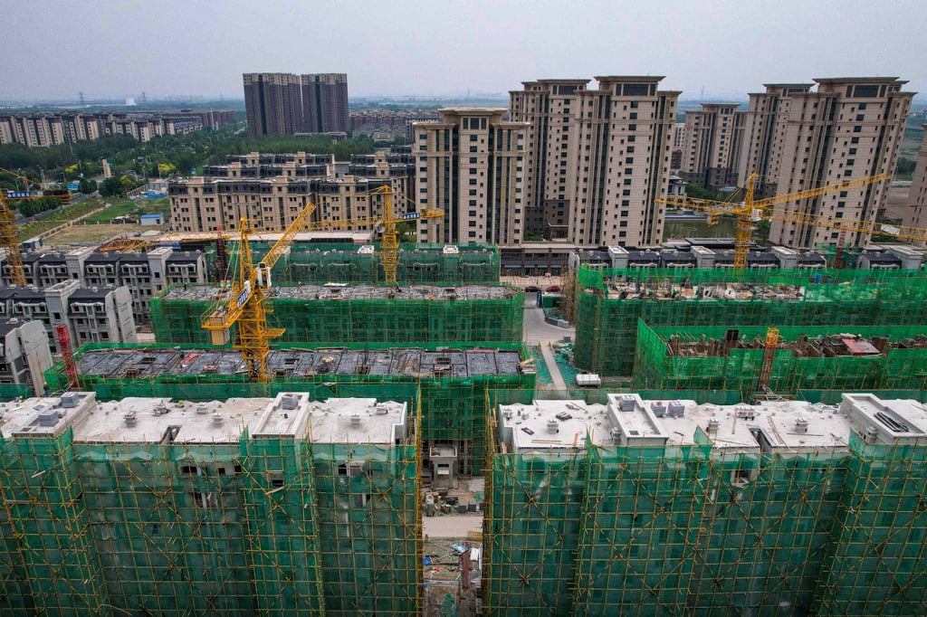 Flats under construction in Tianjin in June. Land sales revenue plunged 19.7 per cent last month. Photo: AFP