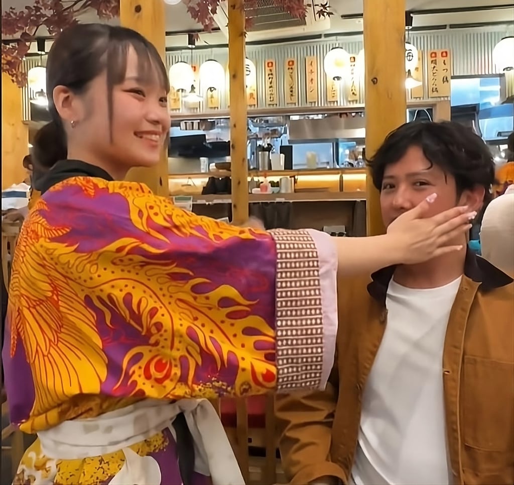 A Yotteba customer prepares to receive a slap to the face in this still from a social media video. He said he paid 600 yen for the service. Photo: TikTok/Salty_Gourmets