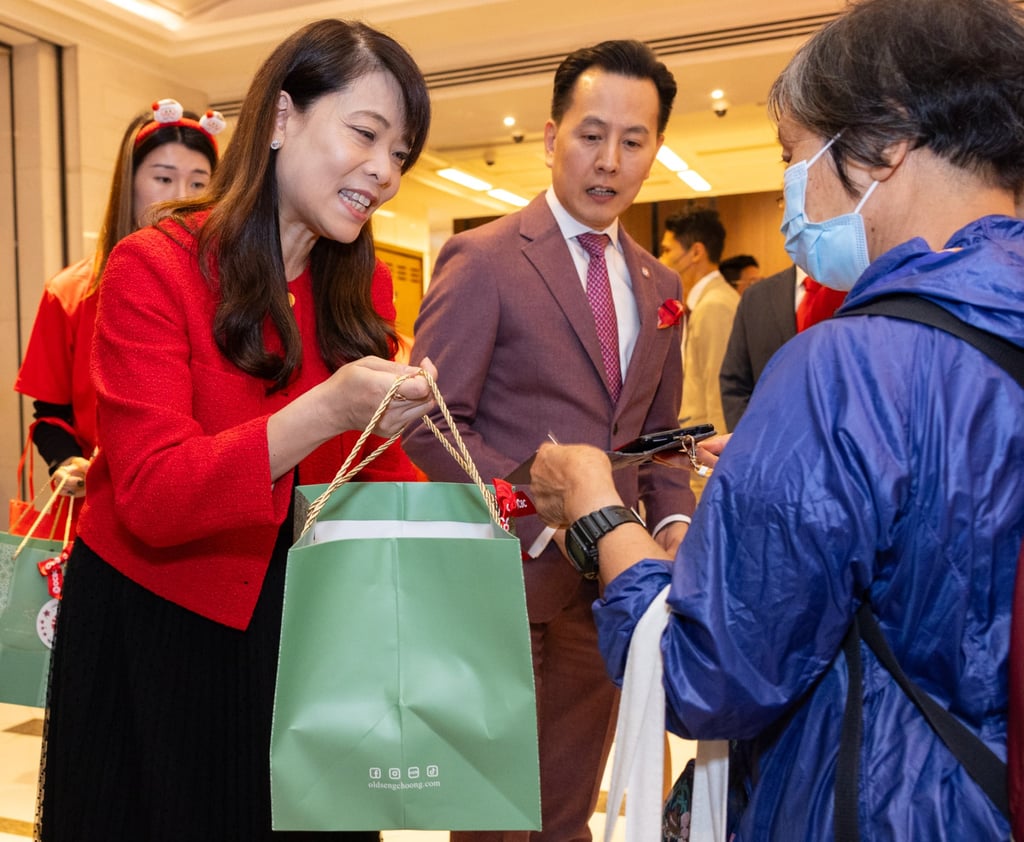 Josephine Lee, head of Consumer Financial Services at OCBC Hong Kong, gives Singaporean pandan cakes to customers in Hong Kong.