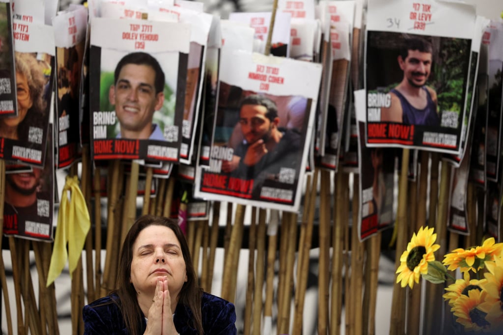 Raz Ben-Ami gestures in front of posters showing captives in Gaza during an event in Tel Aviv, Israel, on Tuesday. Photo: Reuters Raz Ben-Ami gestures in front of posters showing captives in Gaza during an event in Tel Aviv, Israel, on Tuesday. Photo: Reuters