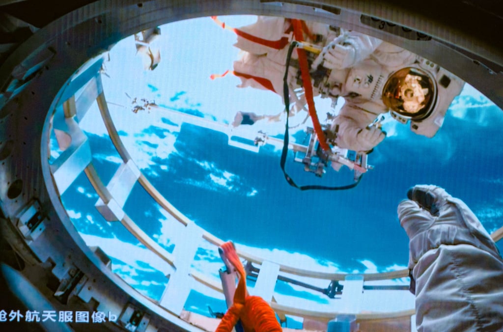 Shenzhou-19 astronaut Cai Xuzhe (above) and Song Lingdong (below) working outside and inside the airlock cabin of China’s orbiting space station, the Tiangong, on Tuesday. Photo: Xinhua