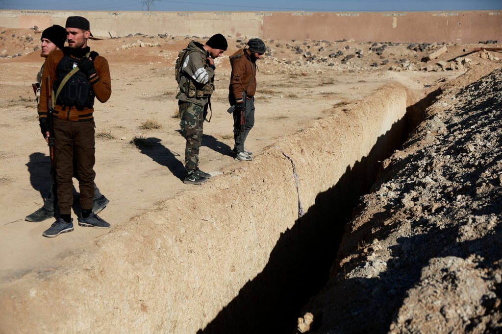 The site of a mass grave in Najha, Syria. Photo: Reuters The site of a mass grave in Najha, Syria. Photo: Reuters
