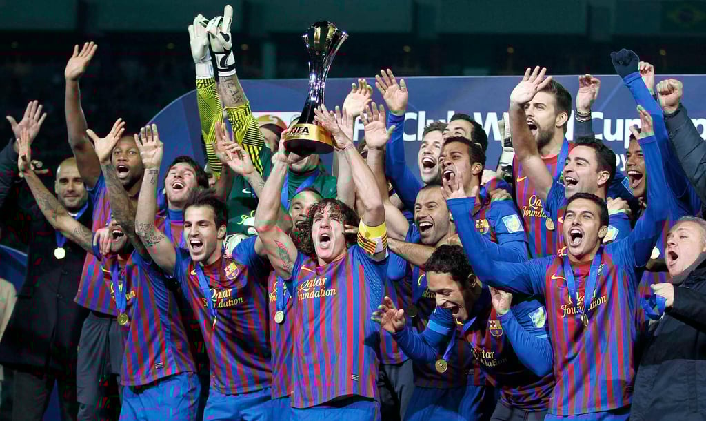 Barcelona’s Carles Puyol lifts the Club World Cup trophy in 2011, with Guardiola (left) watching on. Photo: Reuters Barcelona’s Carles Puyol lifts the Club World Cup trophy in 2011, with Guardiola (left) watching on. Photo: Reuters