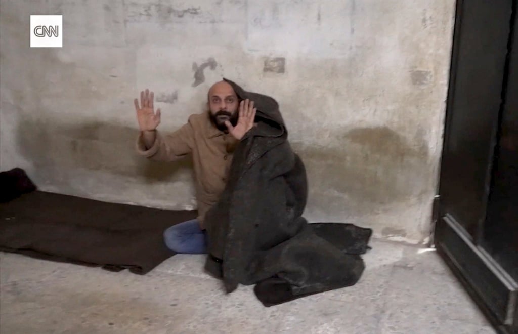 It was later revealed that the prisoner was a former intelligence officer for the Assad government. Photo: CNN via AP It was later revealed that the prisoner was a former intelligence officer for the Assad government. Photo: CNN via AP