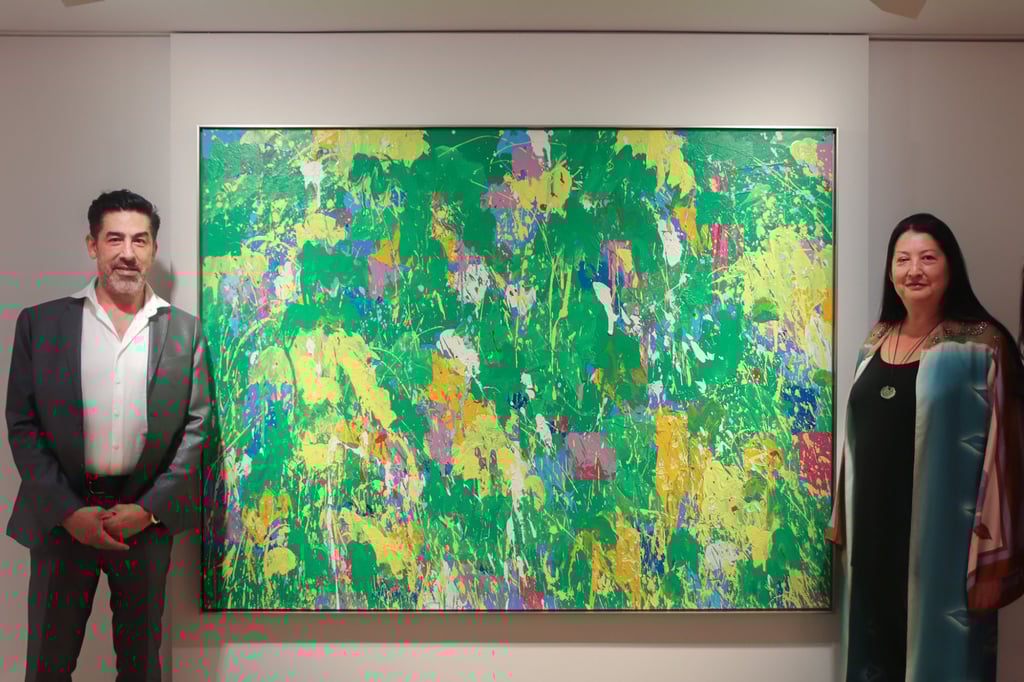 Jesse Ting (left) and Mia Ting stand next to Walasse Ting’s Summer Symphony (Painted with Beethoven Symphony No.4) (1967) at Alisan Fine Arts in Hong Kong. Photo: Alisan Fine Arts