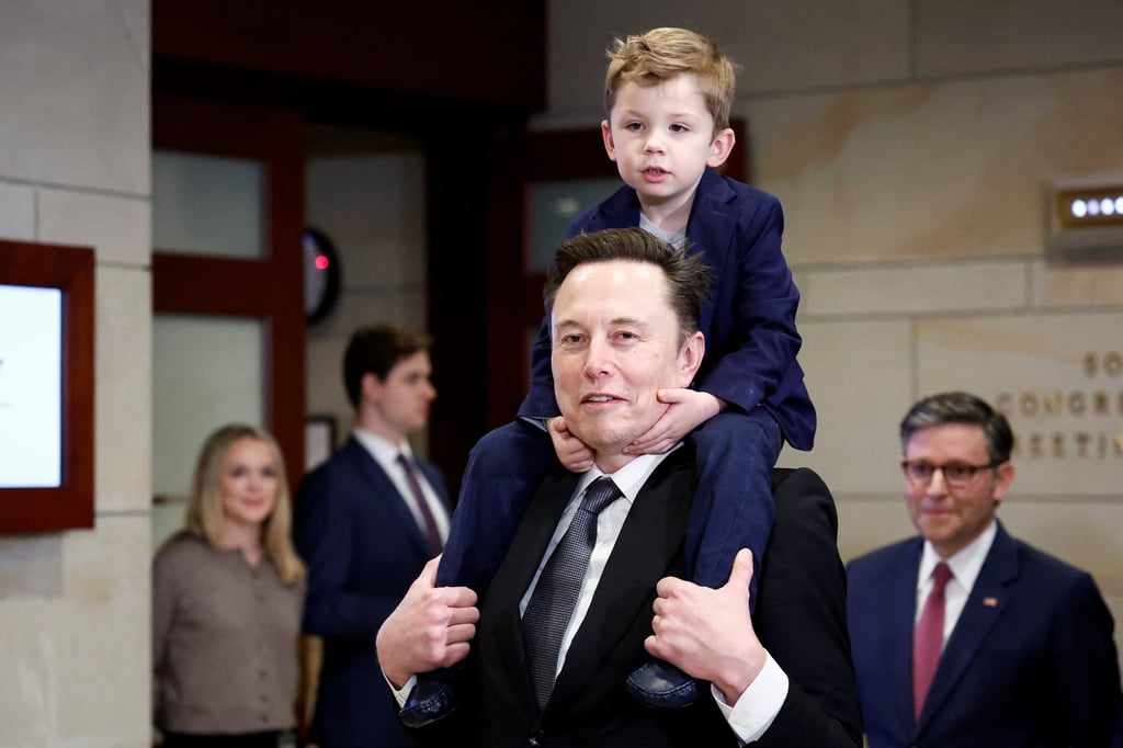 Elon Musk holds his son on his shoulders at Capitol Hill in Washington on December 5. Photo: Reuters