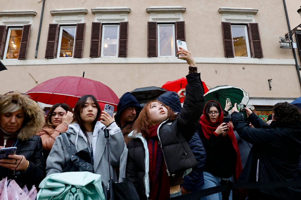 People look at the Trevi Fountain and take pictures as it reopens to the public. Photo: EPA-EFE People look at the Trevi Fountain and take pictures as it reopens to the public. Photo: EPA-EFE