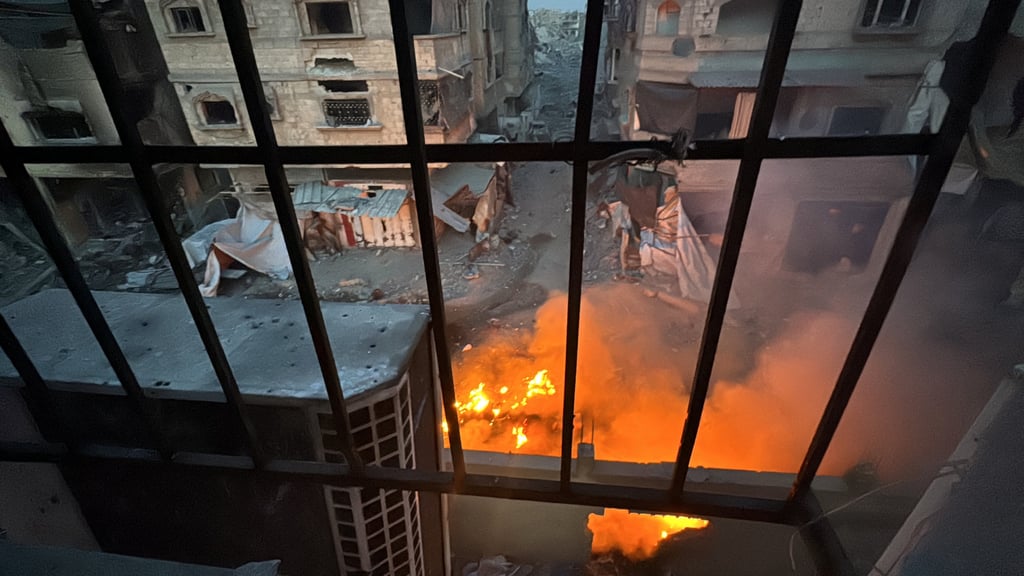 A fire burns as seen through a window from Kamal Adwan hospital, during the ongoing Israeli military operation. Photo: Reuters