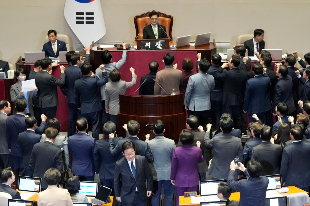 Lawmakers of South Korea’s ruling People Power Party protest to National Assembly Speaker Woo Won-Shik during a plenary session for the impeachment motion against acting President Han Duck-soo. Photo: AP Lawmakers of South Korea’s ruling People Power Party protest to National Assembly Speaker Woo Won-Shik during a plenary session for the impeachment motion against acting President Han Duck-soo. Photo: AP