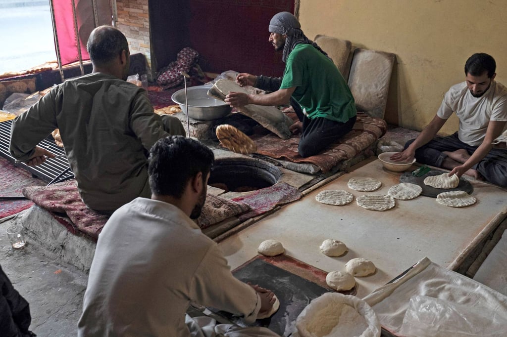 Afghan baker Jamil Ghafori (second from right) and his staff prepare traditional flatbreads, known as naan, at a bakery in Kabul. Photo: AFP Afghan baker Jamil Ghafori (second from right) and his staff prepare traditional flatbreads, known as naan, at a bakery in Kabul. Photo: AFP