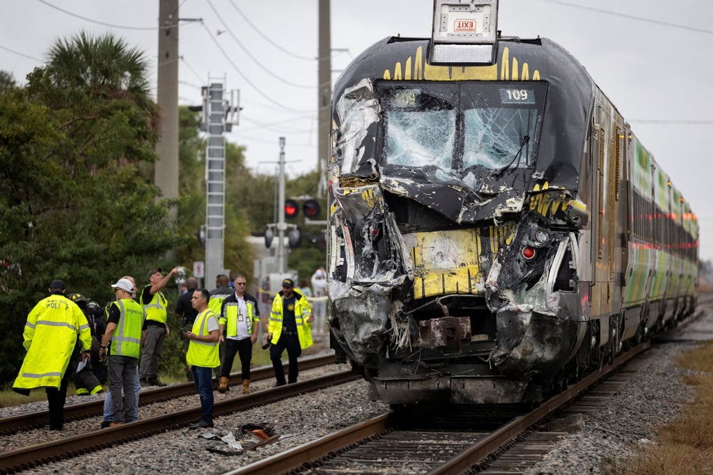 Delray Beach Police officers and Brighline personnel are seen at the scene of a wreckage after a Brightline passenger train collided with a fire truck on railtracks in Delray Beach, Florida. Photo: Reuters