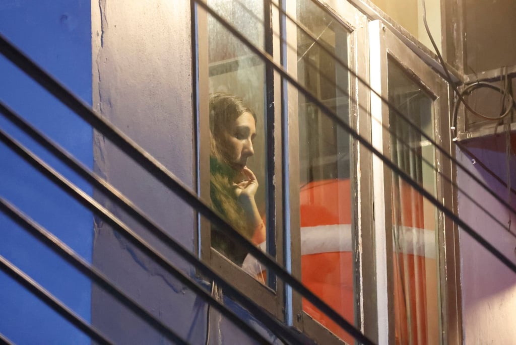 A tourist watches the scene after a blaze at The Ember Hotel in Bangkok. Photo: EPA-EFE