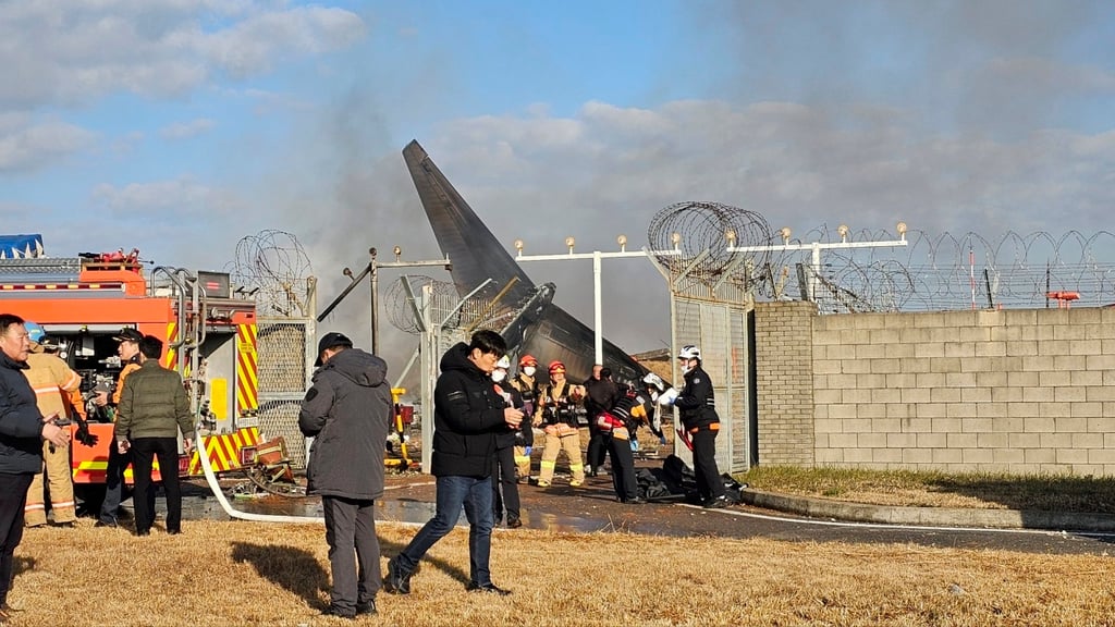 Firefighters and rescue team members work at the Muan International Airport in Muan, South Korea. Photo: AP Firefighters and rescue team members work at the Muan International Airport in Muan, South Korea. Photo: AP