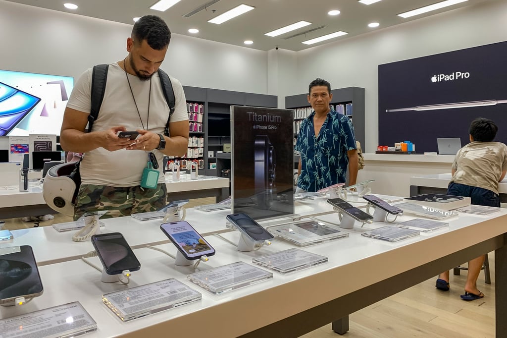A customer inspects an Apple iPhone 15 at a mall in Denpasar, Indonesia’s Bali. Photo: EPA-EFE A customer inspects an Apple iPhone 15 at a mall in Denpasar, Indonesia’s Bali. Photo: EPA-EFE