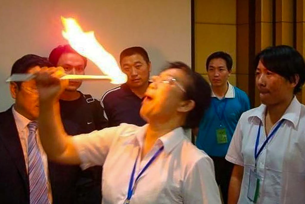 Staff at the company were required to place flaming cotton swabs inside their mouths. Photo: Weibo Staff at the company were required to place flaming cotton swabs inside their mouths. Photo: Weibo