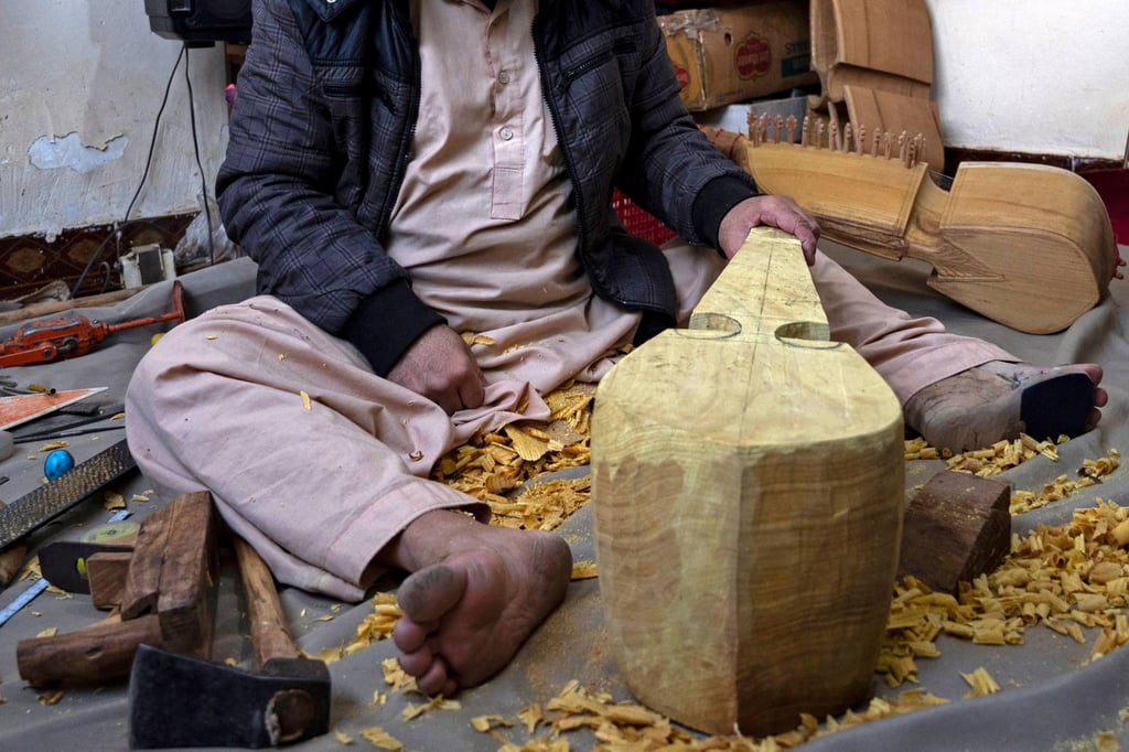 Craftsman Sakhi makes a Rubab at his workshop in Herat, Afghanistan. Photo: AFP
