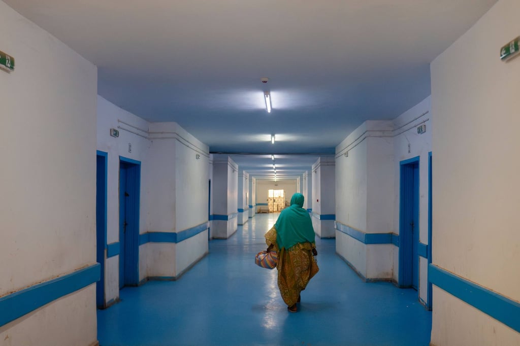 A woman brings food to a relative at the Nouakchott Centre for Specialised Medicine. Photo: AFP