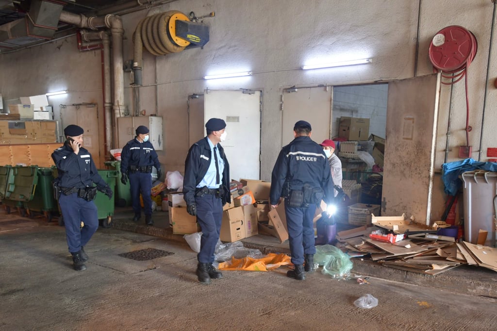 Police officers search Po Tin Estate following the fatal stabbing. Photo: Handout