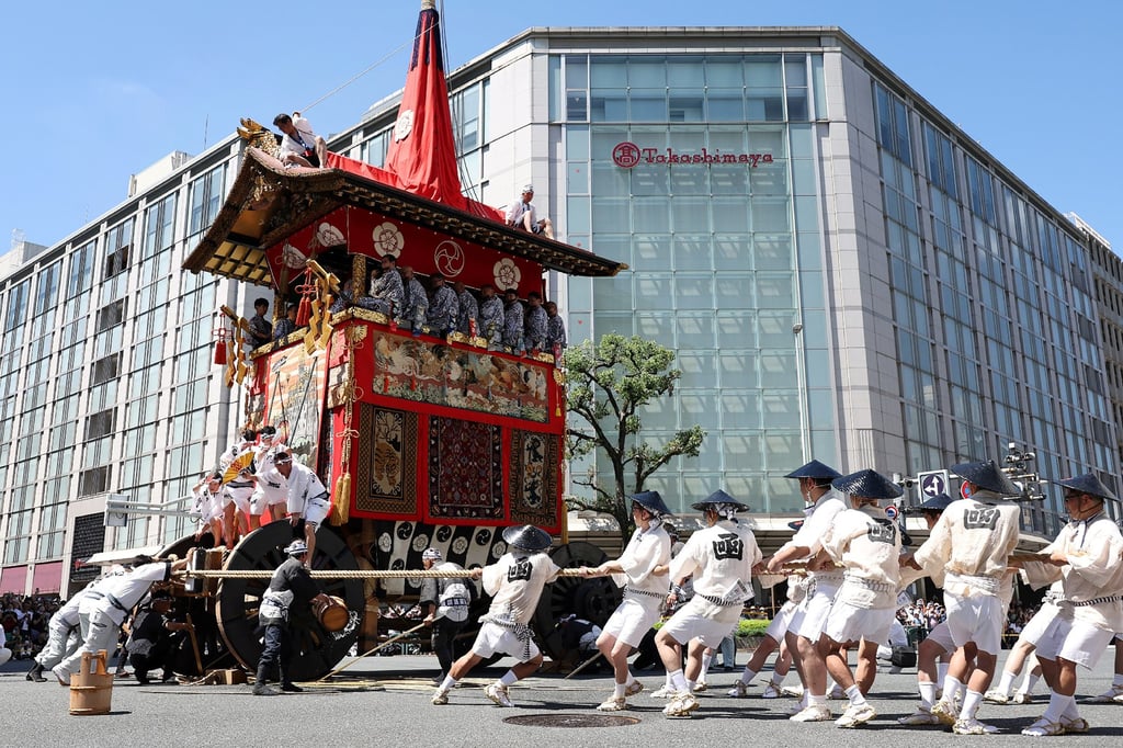 A team pulls a giant float through the streets during the Gion Festival’s Yamahoko parade in Kyoto, Japan, in 2023. Photo: AFP A team pulls a giant float through the streets during the Gion Festival’s Yamahoko parade in Kyoto, Japan, in 2023. Photo: AFP