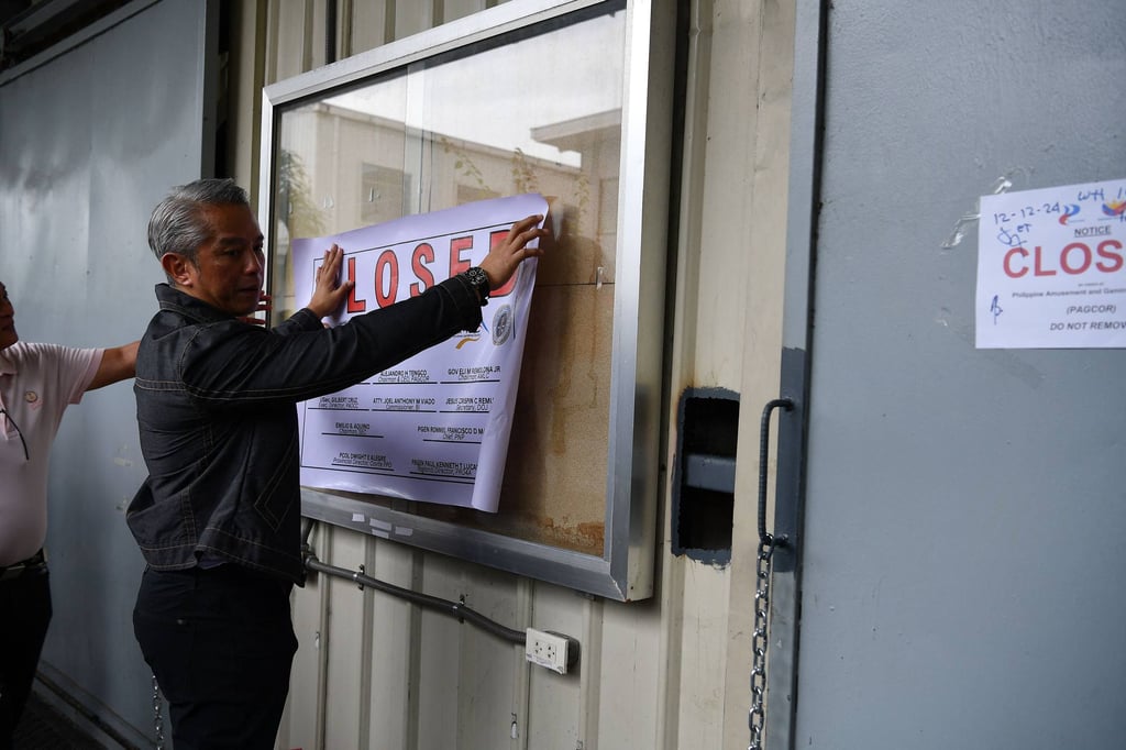 Philippine Interior Secretary Juanito Remulla places the closure sign at a Pogo hub inside the former Island Cove resort in Kawit, Cavite province, on December 17, 2024. Photo: AFP Philippine Interior Secretary Juanito Remulla places the closure sign at a Pogo hub inside the former Island Cove resort in Kawit, Cavite province, on December 17, 2024. Photo: AFP