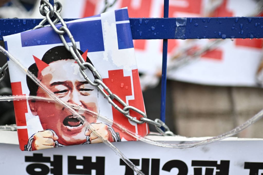 A placard showing Yoon Suk-yeol with horns is seen during a rally against South Korea’s impeached president on Sunday near his residence in Seoul. Photo: AFP