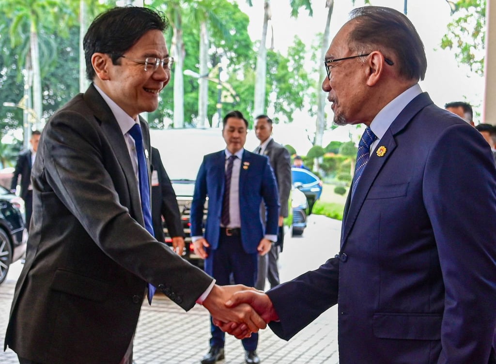 Singapore’s Lawrence Wong and Malaysian PM Anwar Ibrahim greet each other ahead of a meeting in Putrajaya last year. Photo: AFP/ Malaysia’s Department of Information