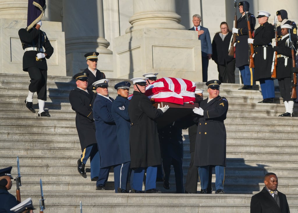 The flag-draped casket of former US President Jimmy Carter is carried by a joint services military honour guard down the steps of the US on January 9. Photo: EPA-EFE/Pool The flag-draped casket of former US President Jimmy Carter is carried by a joint services military honour guard down the steps of the US on January 9. Photo: EPA-EFE/Pool