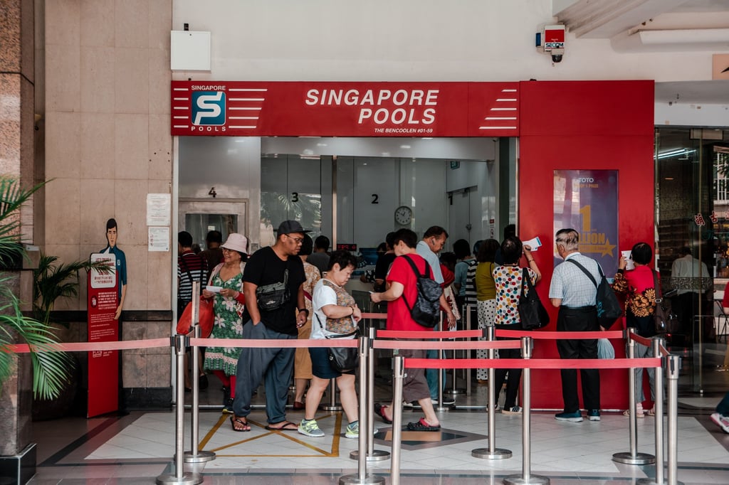 Customers buy lottery tickets at a Singapore Pools shop. Singapore Pools is the only legal lottery operator in Singapore. Photo: Shutterstock Customers buy lottery tickets at a Singapore Pools shop. Singapore Pools is the only legal lottery operator in Singapore. Photo: Shutterstock