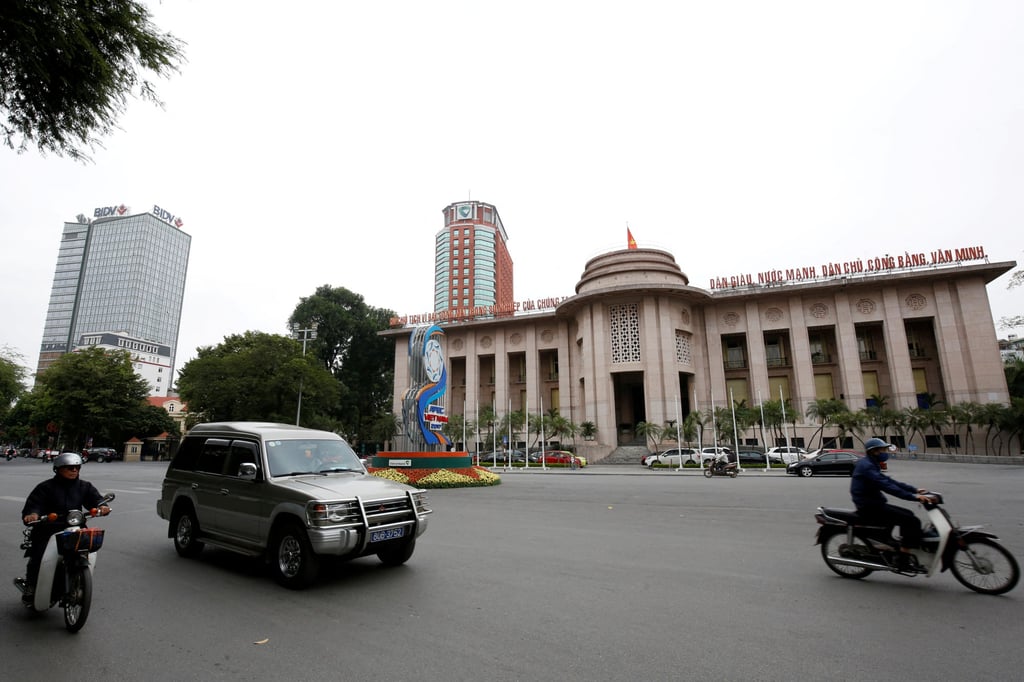 People go past the State Bank building, near the offices of Vietcombank and the Bank for Investment and Development of Vietnam, in central Hanoi, Vietnam. Photo: Reuters People go past the State Bank building, near the offices of Vietcombank and the Bank for Investment and Development of Vietnam, in central Hanoi, Vietnam. Photo: Reuters