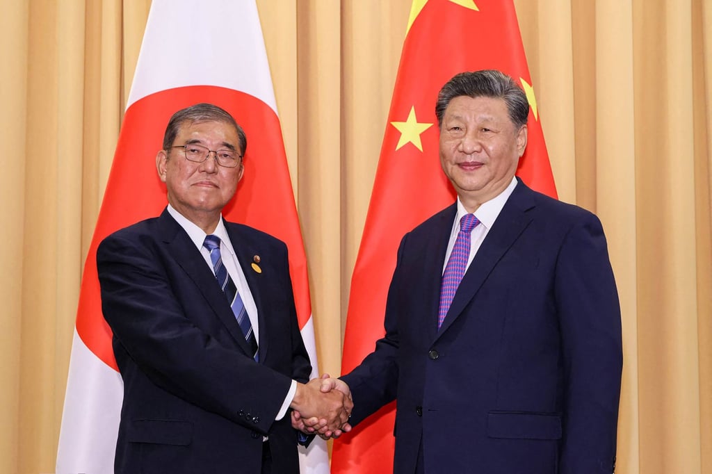 Japan’s Prime Minister Shigeru Ishiba (left) shakes hands with China’s President Xi Jinping (right) during their meeting on the sidelines of the Apec summit in the Peruvian capital Lima. Photo: Cabinet Public Relations Office/AFP Japan’s Prime Minister Shigeru Ishiba (left) shakes hands with China’s President Xi Jinping (right) during their meeting on the sidelines of the Apec summit in the Peruvian capital Lima. Photo: Cabinet Public Relations Office/AFP