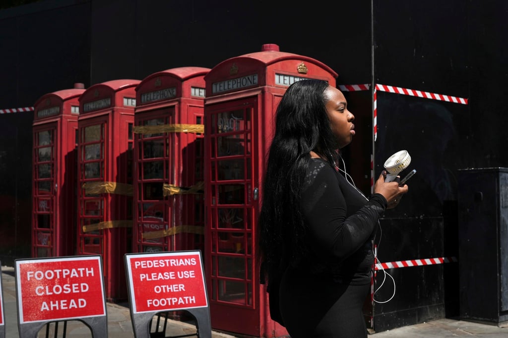 A woman cools herself with a fan during a hot day in London. File photo: AP A woman cools herself with a fan during a hot day in London. File photo: AP