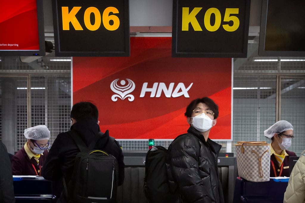 Travelers at the Hainan Airlines check-in counter at Beijing Capital International Airport, March 6, 2020. Photo: AP Travelers at the Hainan Airlines check-in counter at Beijing Capital International Airport, March 6, 2020. Photo: AP