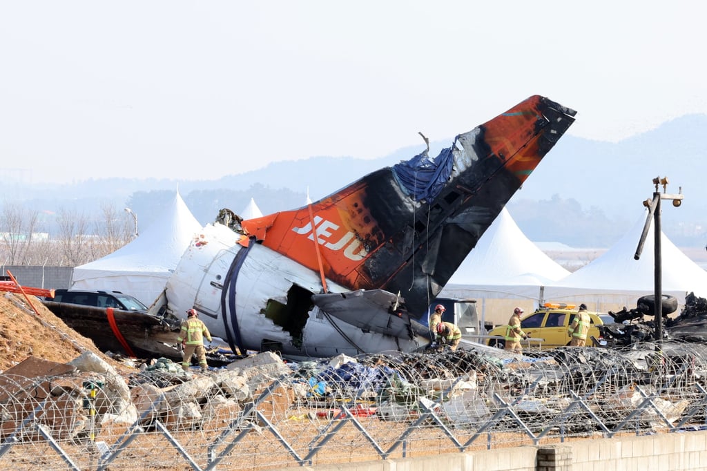 Firefighters remove tarpaulin sheets covering the debris of a Jeju Air passenger plane at Muan International Airport in Muan, southwestern South Korea, on January 13, 2025. Photo: EPA-EFE/Yonhap Firefighters remove tarpaulin sheets covering the debris of a Jeju Air passenger plane at Muan International Airport in Muan, southwestern South Korea, on January 13, 2025. Photo: EPA-EFE/Yonhap